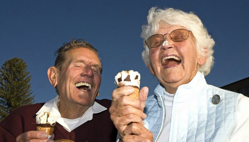 Senior couple happily eating an ice cream