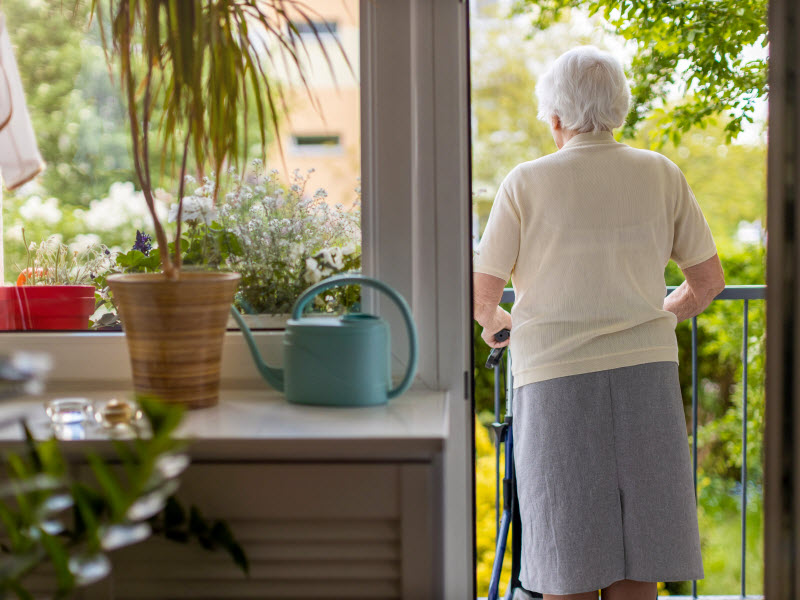 senior woman with walking frame at home